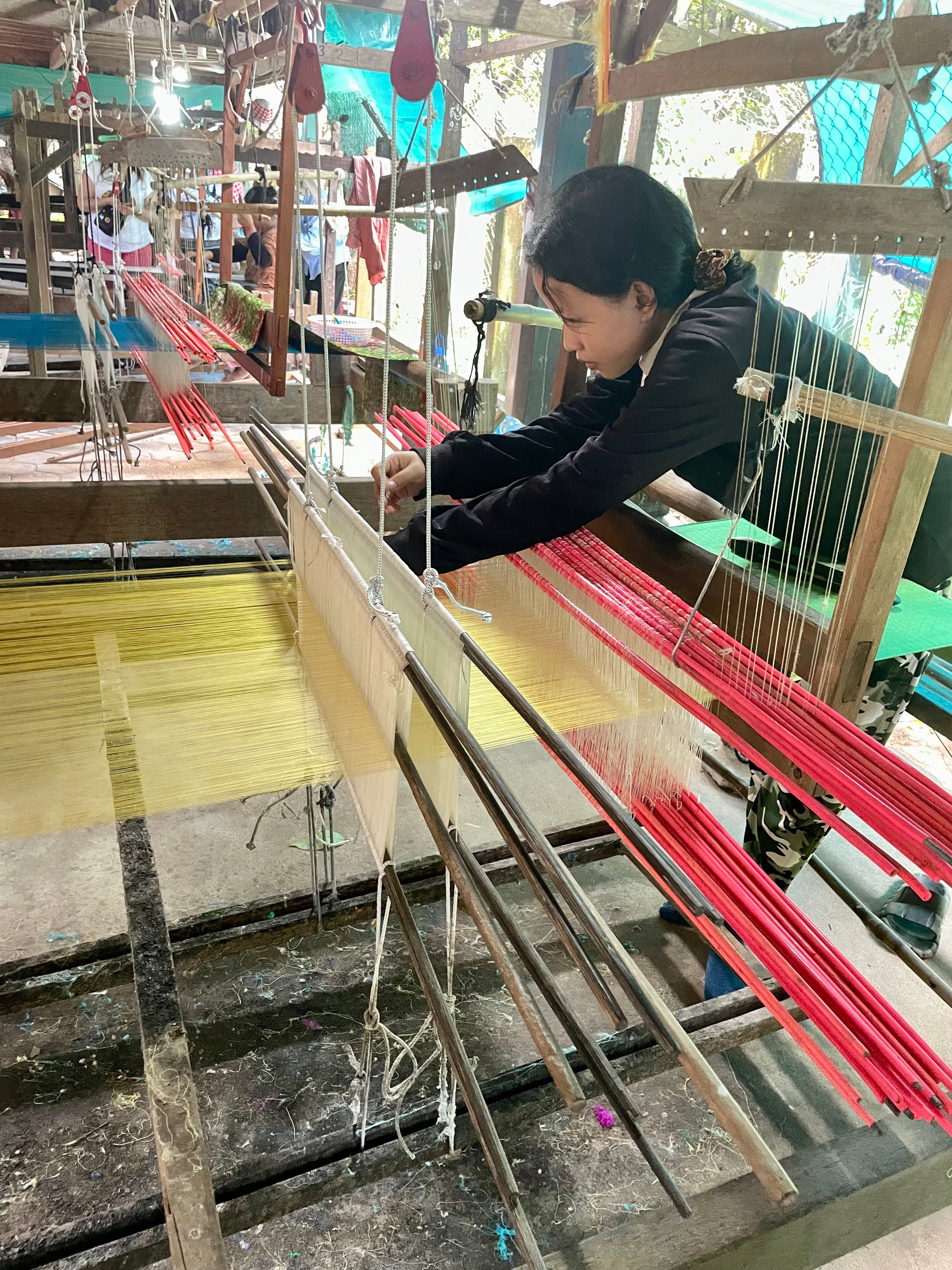 Young woman weaving silk